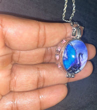 Load image into Gallery viewer, Silver dragon pendant necklace with blue wings and heart details.