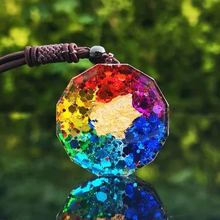 Load image into Gallery viewer, Rainbow chakra pendant with gold leaf, on a brown cord necklace. Handmade resin jewelry.